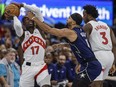 Orlando Magic guard Jalen Suggs fouls Toronto Raptors guard Dennis Schroder (17) while O.G. Anunoby sets up screen.