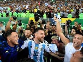 Argentina's Lionel Messi (centre) celebrates with teammates after their victory against Brazil.