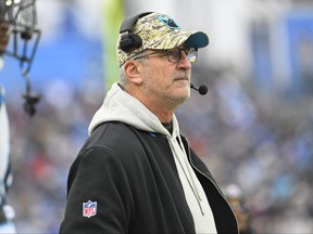 Carolina Panthers head coach Frank Reich watches from the sideline during the first half of an NFL football game against the Tennessee Titans.
