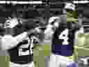 Dallas Cowboys cornerback DaRon Bland, left, and quarterback Dak Prescott celebrate by eating Thanksgiving turkey legs.