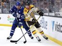Brandon Carlo of the Boston Bruins and John Tavares of the Toronto Maple Leafs battle for control of the puck during the second period at TD Garden on November 02, 2023 in Boston, Massachusetts.