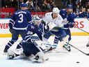 Ilya Samsonov of the Toronto Maple Leafs makes a save in the last minute of play as Dakota Joshua of the Vancouver Canucks looks for the rebound at Scotiabank Arena on November 11, 2023 in Toronto, Ontario, Canada.