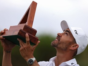 Camilo Villegas of Colombia looks skyward with a trophy.