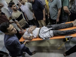 Palestinians injured in airstrikes arrive at Nasser Medical Hospital in Khan Yunis, Gaza, Saturday, Nov. 18, 2023.