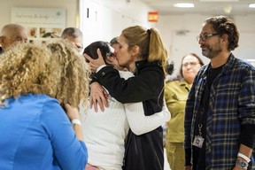 This handout picture released by the Israeli army shows a former Israeli hostage reunited with family members following her release by Hamas from the Gaza Strip, at the Sourasky Medical Center in Tel Aviv early on Nov. 28, 2023.