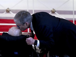 James "Chip" Carter kisses the head of his father, former U.S. president Jimmy Carter.