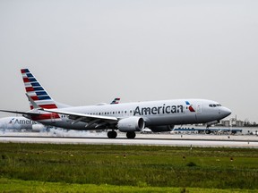 In this file photo taken on June 16, 2021, an American Airlines plane lands at the Miami International Airport in Miami.