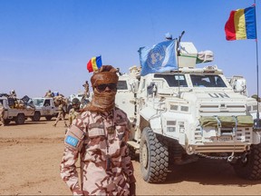 A UN soldier in front of a convoy.