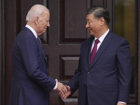 U.S. President Joe Biden greets Chinese President Xi Jinping.