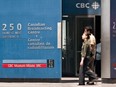 Pedestrians walk in front of the CBC building in downtown Toronto, June 7, 2006.