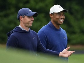 Rory McIlroy, of Northern Ireland, and Tiger Woods walk on the 11th fairway during a practice for the Masters golf tournament at Augusta National Golf Club, Monday, April 3, 2023, in Augusta, Ga.