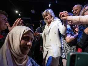 Mississauga Mayor Bonnie Crombie is helped off a stage.
