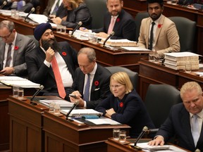Finance Minister Peter Bethlenfalvy, lower centre, looks at his phone as he attends question period at Queen's Park in Toronto on Thursday November 2, 2023.