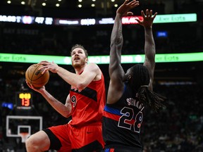 Toronto Raptors centre Jakob Poeltl (19) attacks the net while guarded by Detroit Pistons centre Isaiah Stewart (28) during second half NBA basketball action, in Toronto, Sunday, Nov. 19, 2023.