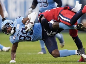 Alouettes defensive back Reggie Stubblefield (right) tackles Argonauts wide receiver Cam Phillips (left) during first half CFL Eastern Conference final action in Toronto, Saturday, Nov. 11, 2023.