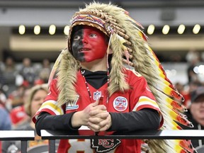 A young Kansas City Chiefs fan, dressed with a headdress and face paint, looks on during an NFL game against the Las Vegas Raiders, Sunday, Nov. 26, 2023, in Las Vegas.