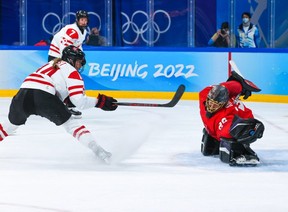 Swiss goaltender Saskia Maurer makes a glove save on Team Canada’s Renata Fast during the 2022 Beijing Games. Gavin Young/Postmedia files