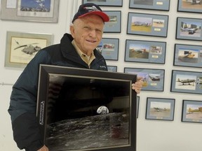 Apollo 8 Commander Frank Borman poses in Billings, Mont, with a photograph of Earth taken as his spaceship orbited the moon 45 years ago.