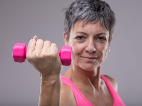 Fit determined woman working out with weights