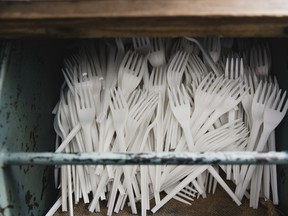 A drawer of disposable plastic forks.