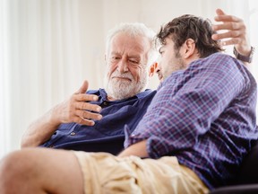 old man serious discussion with younger man