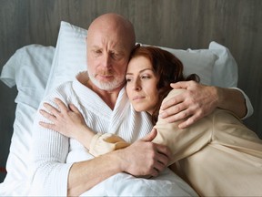 Loving couple lying on comfortable bed