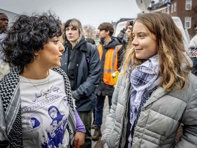 Swedish climate activist Greta Thunberg (R) and Dutch-Afghan Sahar Shirzad attend a march for climate and justice, in Amsterdam