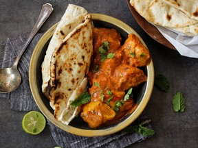 Butter chicken served with naan bread