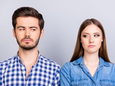 Mistrust and cheat problems. Annoyed couple is ignoring each other, but spy each other secretly, they stand on pure background in casual shirts