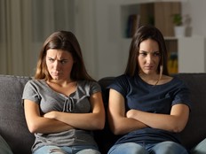 two siblings ignoring each other at home