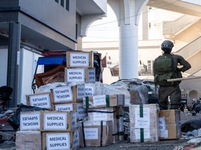 This handout picture released by the Israeli army on Wednesday, Nov. 15, 2023, shows a soldier standing outside Al-Shifa hospital next to boxes of medical supplies the army said it had delivered to the health centre during their operation at Al-Shifa in Gaza City, amid continuing battles between Israel and the Palestinian militant group Hamas.