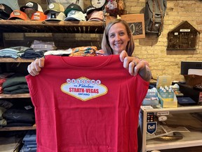 Employee Christine MacTavish shows off a 'Strath-Vegas' T-shirt sold at Yellow Brick General in downtown Strathroy. The shirt is a tongue-and-cheek play on the town being on the sleepy side at times. IAN SHANTZ/TORONTO SUN