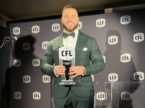 Blue Bombers running back Brady Oliveira poses with the Most Outstanding Canadian award Thursday night in Niagara Falls.