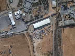 This image provided by Maxar Technologies shows a close view of the Rafah border crossing between Gaza and Egypt, with humanitarian-associated trucks lined up at and near the border, Tuesday, Nov. 7, 2023.