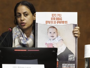 Ofri Bibas Levy, sister of Yarden Bibas, held hostage in Gaza with his wife, Shiri and two kids, Kfir and Ariel, talks to the media, during a press conference at the European headquarters of the United Nations in Geneva, Switzerland, Tuesday, Nov. 14, 2023.
