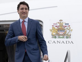 Justin Trudeau steps off an airplane