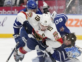 Florida Panthers left wing Matthew Tkachuk (19) collides with Toronto Maple Leafs goaltender Joseph Woll (60)