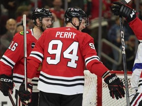 Chicago Blackhawks right wing Corey Perry (94) celebrates with teammates after his goal during the third period of an NHL hockey game against the Tampa Bay Lightning, Thursday, Nov. 16, 2023, in Chicago. (AP Photo/Erin Hooley)