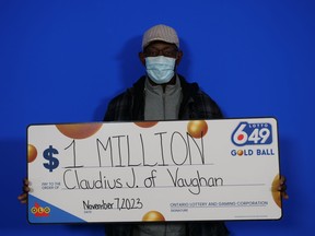 Claudius John holds his $1-million cheque after winning on the Oct. 7, 2023 Lotto 6/49 gold ball ticket.