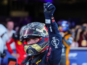 Red Bull Racing's Dutch driver Max Verstappen greets the fans after achieving pole position during the qualifying session for the Abu Dhabi Formula One Grand Prix at the Yas Marina Circuit in the Emirati city on Nov. 25, 2023.