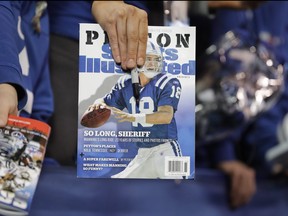 A person holds a Sports Illustrated magazine.