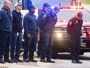 Members of the Austin Fire Department bow their heads