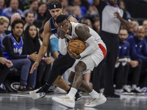 Toronto Raptors guard Dennis Schroder, right, reacts after being fouled by Orlando Magic guard Jalen Suggs during the first half of an NBA basketball In-Season Tournament game Tuesday, Nov. 21, 2023, in Orlando, Fla. (AP Photo/Kevin Kolczynski)