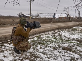A Ukrainian soldier holds an anti-drone gun
