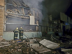 In this photo provided by Odesa City Administration, Ukrainian emergency workers examine the site of the Russian rocket attack in central Odesa, Ukraine, early hours on Monday, Nov. 6, 2023.