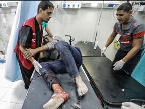 Palestinians injured in Israeli raids arrive at Nasser Medical Hospital on Nov. 13, 2023 in Khan Yunis, Gaza.