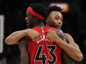 Raptors forwards Pascal Siakam (43) and Scottie Barnes (right) celebrate a basket against the 76ers during second half NBA action in Toronto, Oct. 26, 2022.