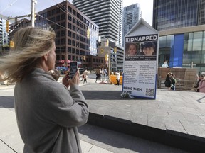 A large milk carton with the names, faces and stories of eight Israeli children kidnapped and held by Hamas terrorists since Oct. 7 is seen on display at Yonge and Eglinton on Thursday, Nov. 9, 2023. It is reminiscent of the mid-80s "Missing Children Milk Carton Program" launched in the U.S. by the non-profit National Child Safety Council.