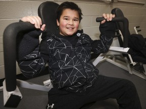 George Guinto, 12, works out on weight machines with his dad Brian at Variety Village on Wednesday, Nov. 22, 2023.