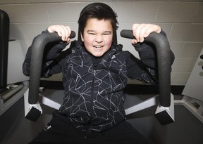 George Guinto, 12, works out on weight machines with his dad Brian at Variety Village on Wednesday, Nov. 22, 2023.